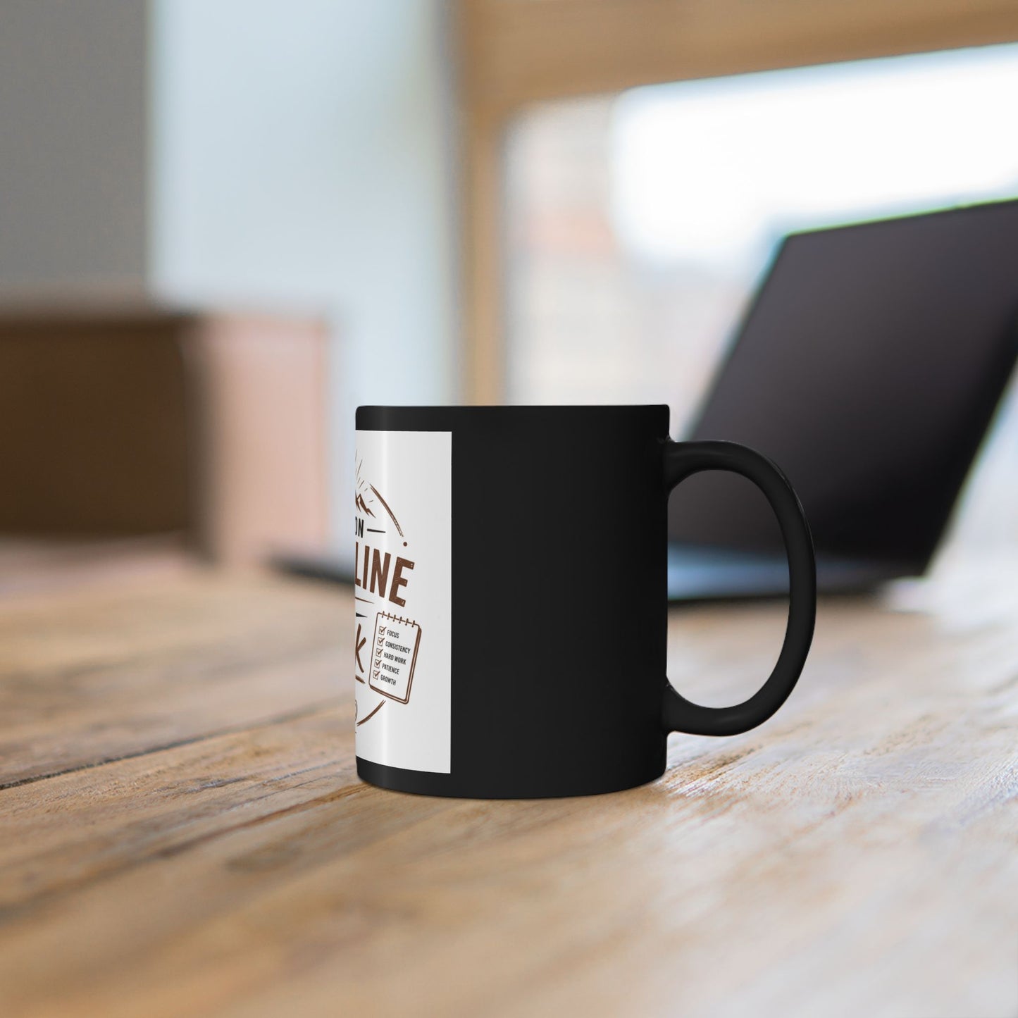 Black mug with a white label on a wooden surface