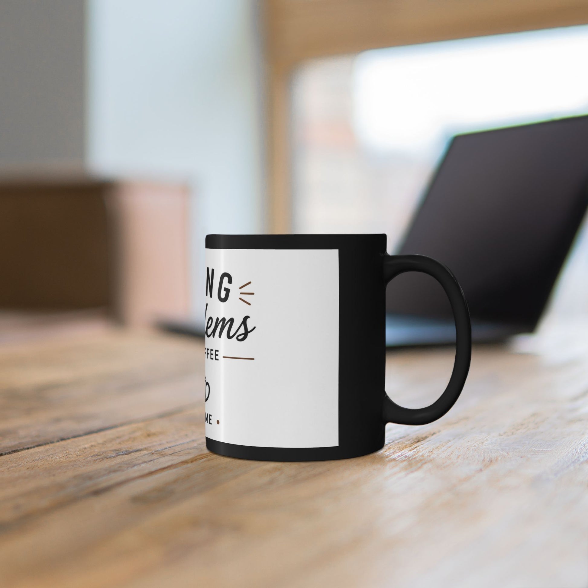 Black coffee mug on office desk with laptop and coffee showing Fixing Problems One Coffee at a Time funny work design