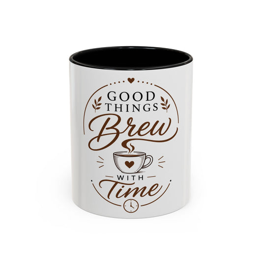 White ceramic coffee mug with black interior featuring “Good Things Brew With Time” coffee and leaf design in brown tones