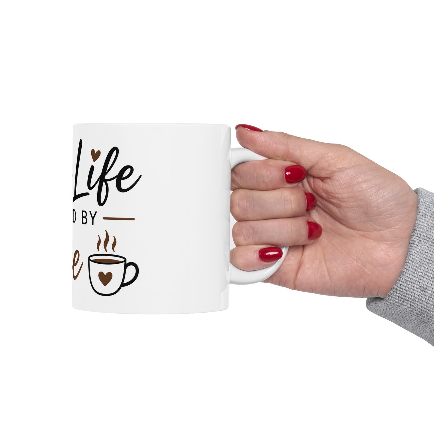 Person holding Mom Life Powered by Coffee ceramic mug showing funny Mother’s Day coffee design