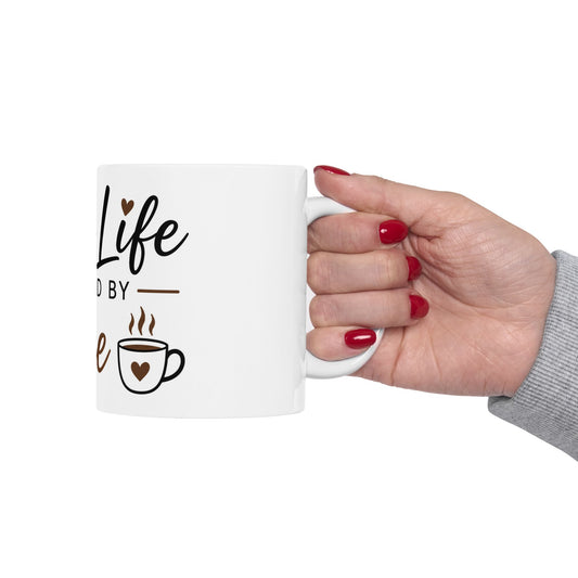 Person holding Mom Life Powered by Coffee ceramic mug showing funny Mother’s Day coffee design