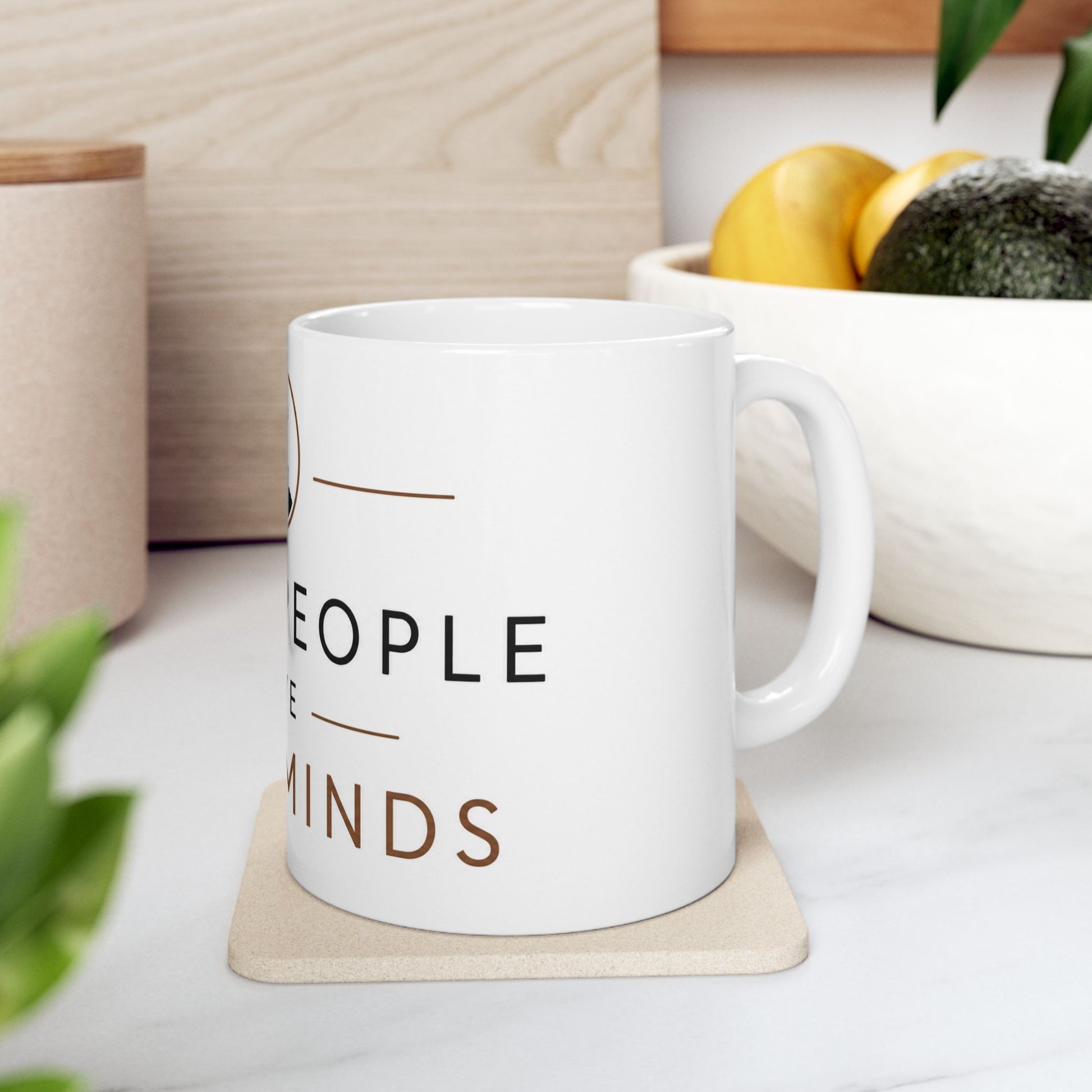 White ceramic coffee mug on wooden table with coffee showing Quiet People Have Loud Minds introvert design