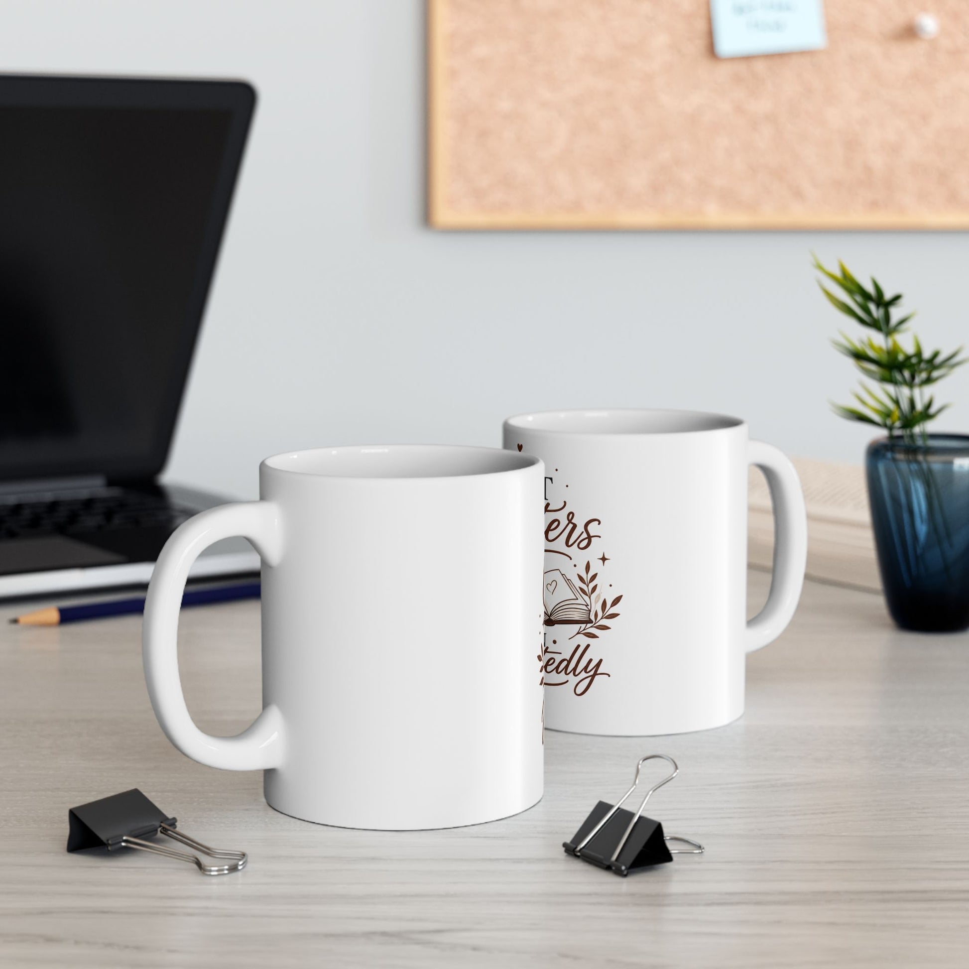 Black inspirational coffee mug on desk with laptop and morning coffee setup showing The Best Chapters Begin Unexpectedly design